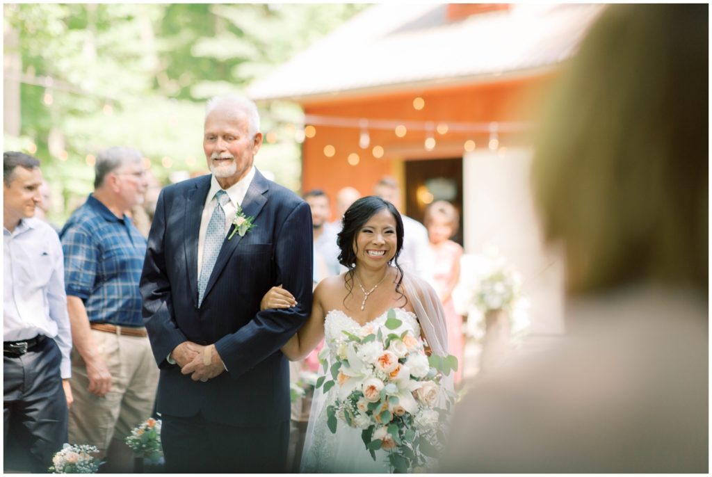 Bride is emotional as she walks down the aisle at her Gable Hill wedding in Marcellus MI, photo by Grand Rapids wedding photographer Cynthia Boyle