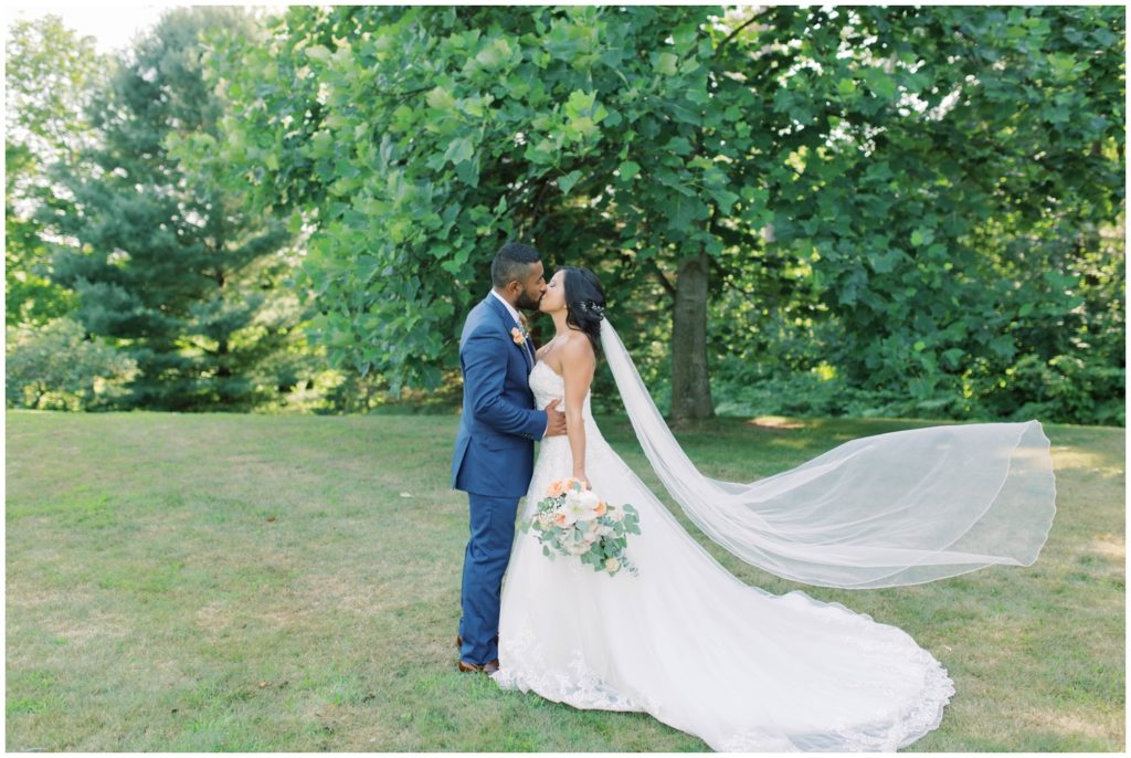bride and groom kiss at their Michigan wedding venue, Gable Hill, photo by Grand Rapids wedding photographer Cynthia Boyle