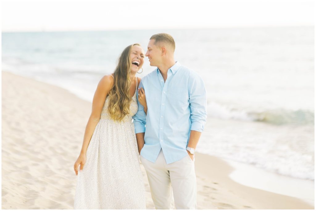 Couple laughs at their South haven beach engagement session, photo by wedding photographer in Grand Rapids Cynthia Boyle Photography
