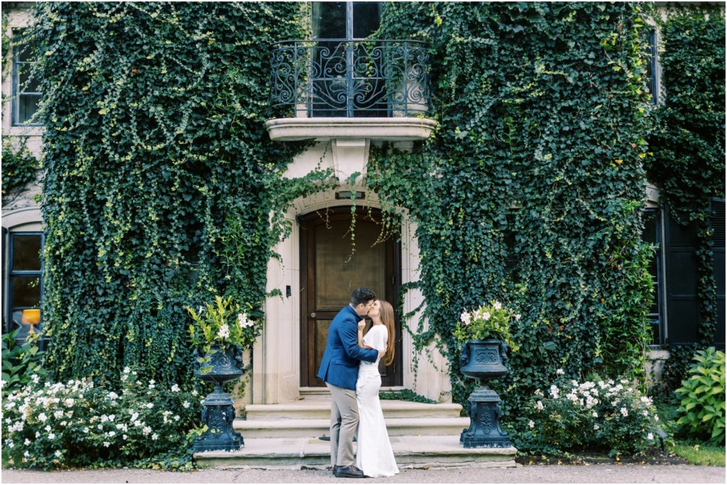 Ashley and Owen kiss in front of Greencrest Manor in Battle Creek, MI. Photo by Cynthia Mae Photography