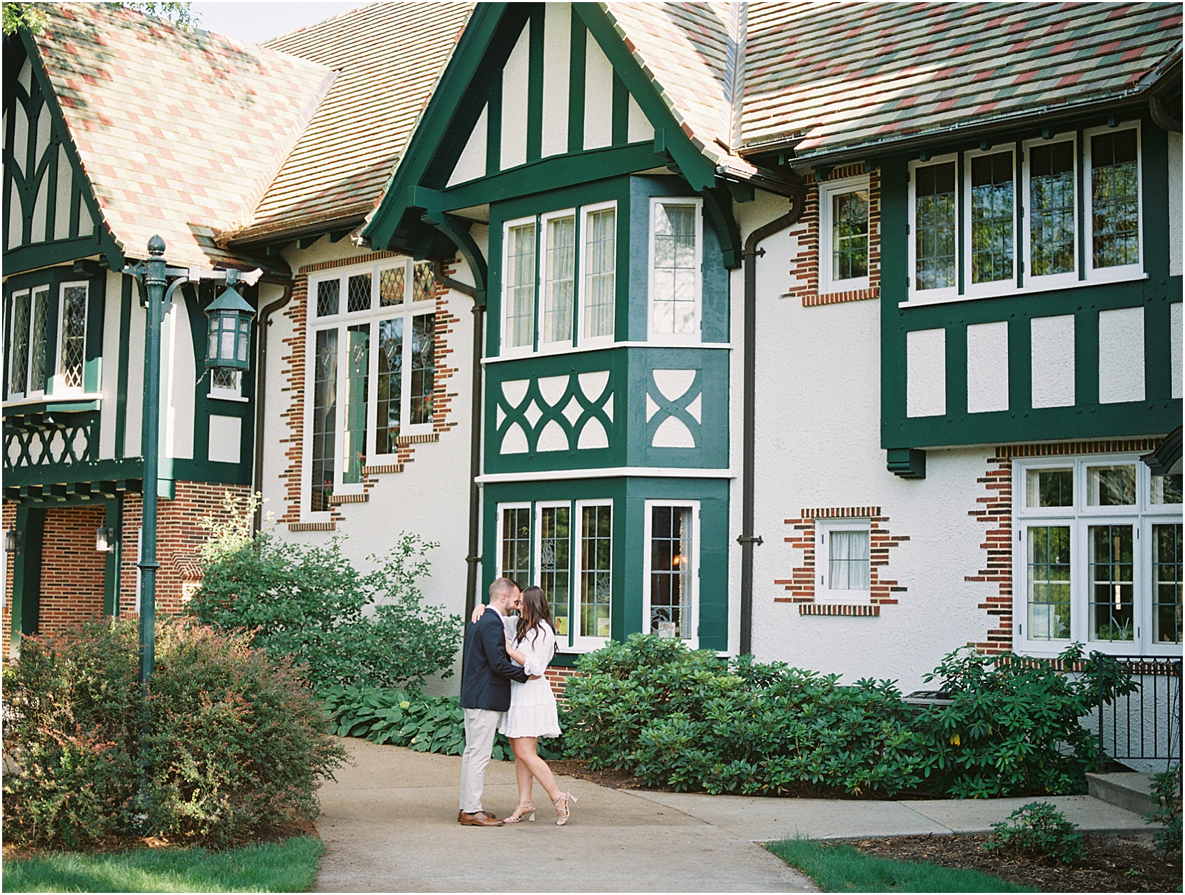 Madison and Dillon embrace each other in front of Kellogg Manor House in Hickory Corners, Michigan photo by Cynthia Mae Photography
