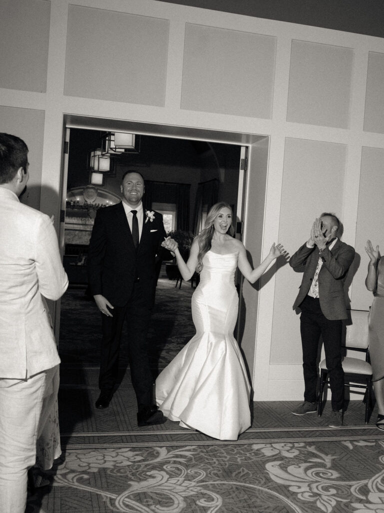 Bride and groom entering their reception