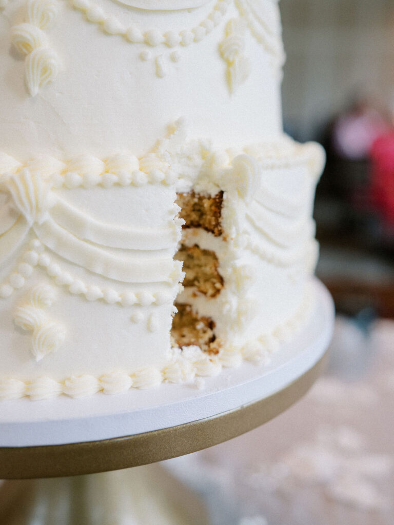 A small slice taken out of the wedding cake after first cut