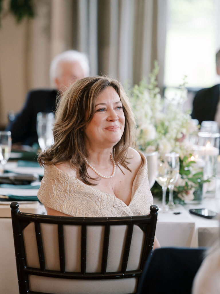 Mother of the bride smiling during speeches