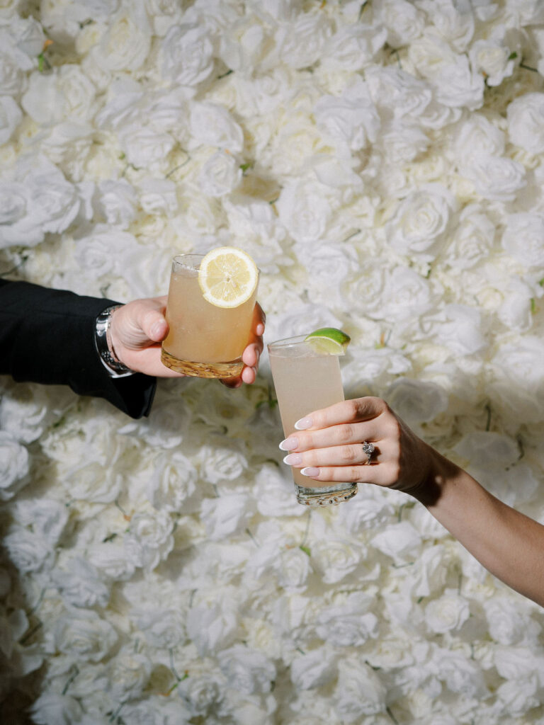 Bride and groom toasting their drinks during their Cascade Hills Country Club wedding in Grand Rapids, Michigan