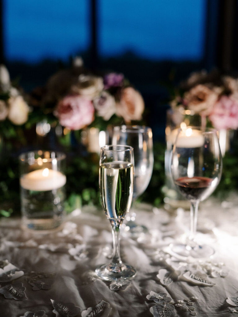 Candlelit reception table and drink glasses