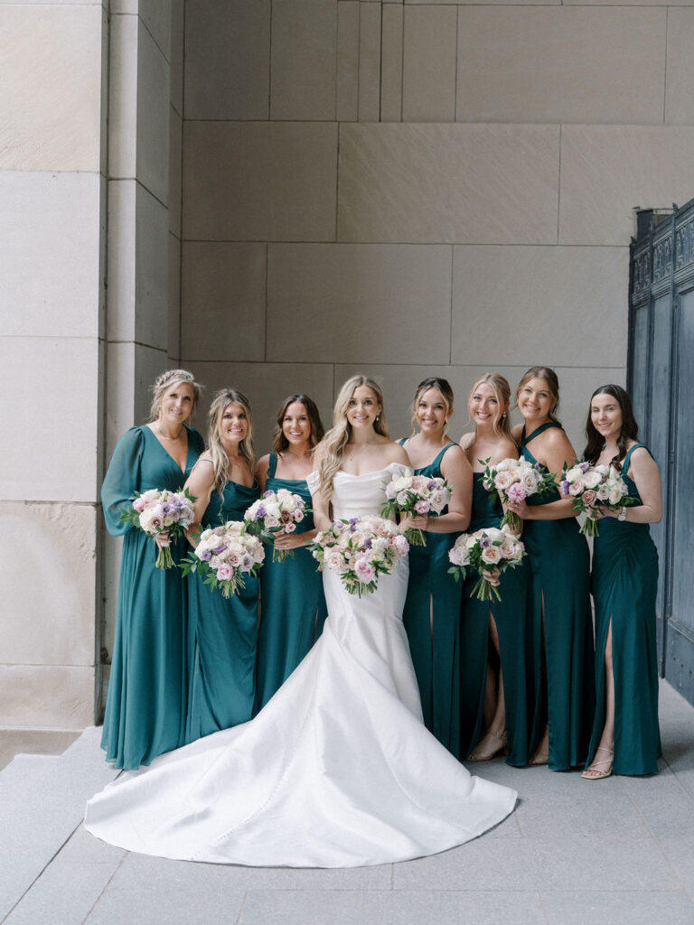 Bride and bridesmaids posing together at the Civic Auditorium in downtown Grand Rapids.