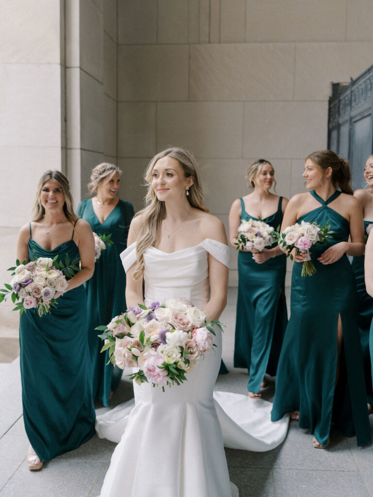 Bride and bridesmaids posing together at the Civic Auditorium in downtown Grand Rapids.