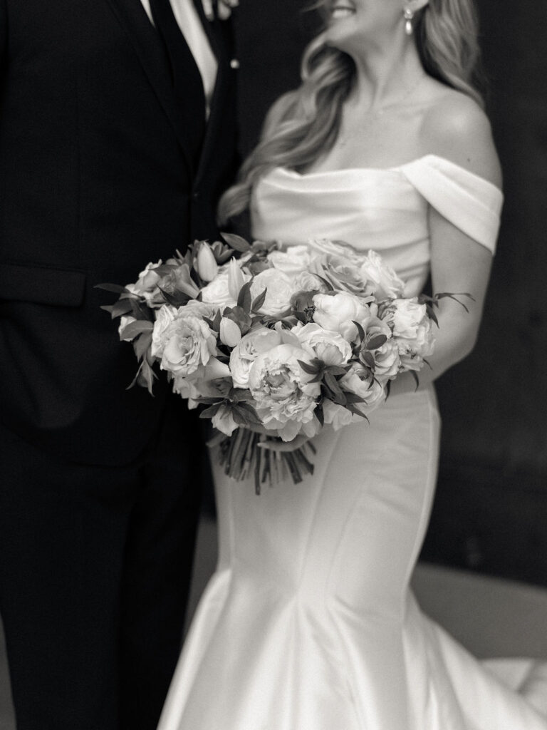 Black and white close up shot of a bride and groom posing together