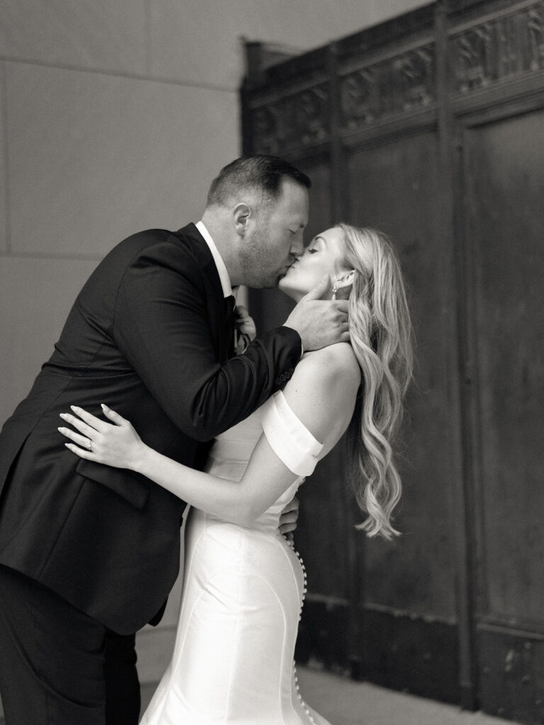 Black and white photo of a bride and groom kissing at the Civic Auditorium in downtown Grand Rapids.
