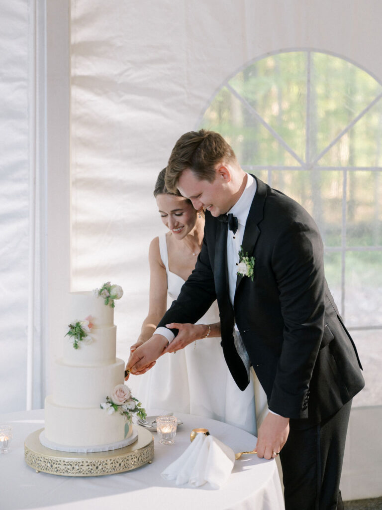 Bride and groom cutting into their wedding cake