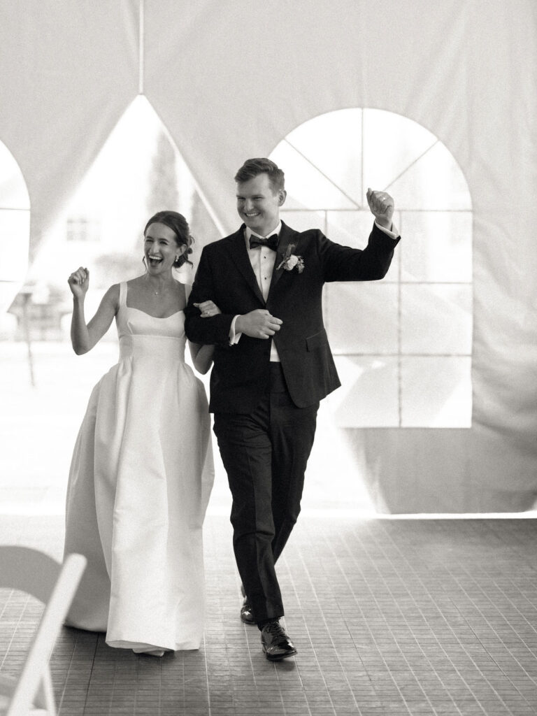 Bride and groom entering their wedding reception