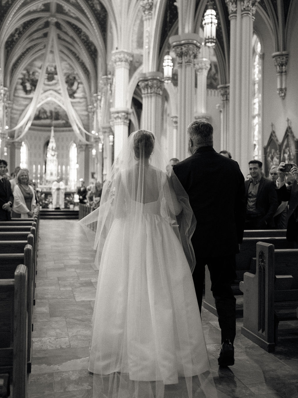 Bride walking down the aisle with her father for her Notre Dame Basilica wedding ceremony