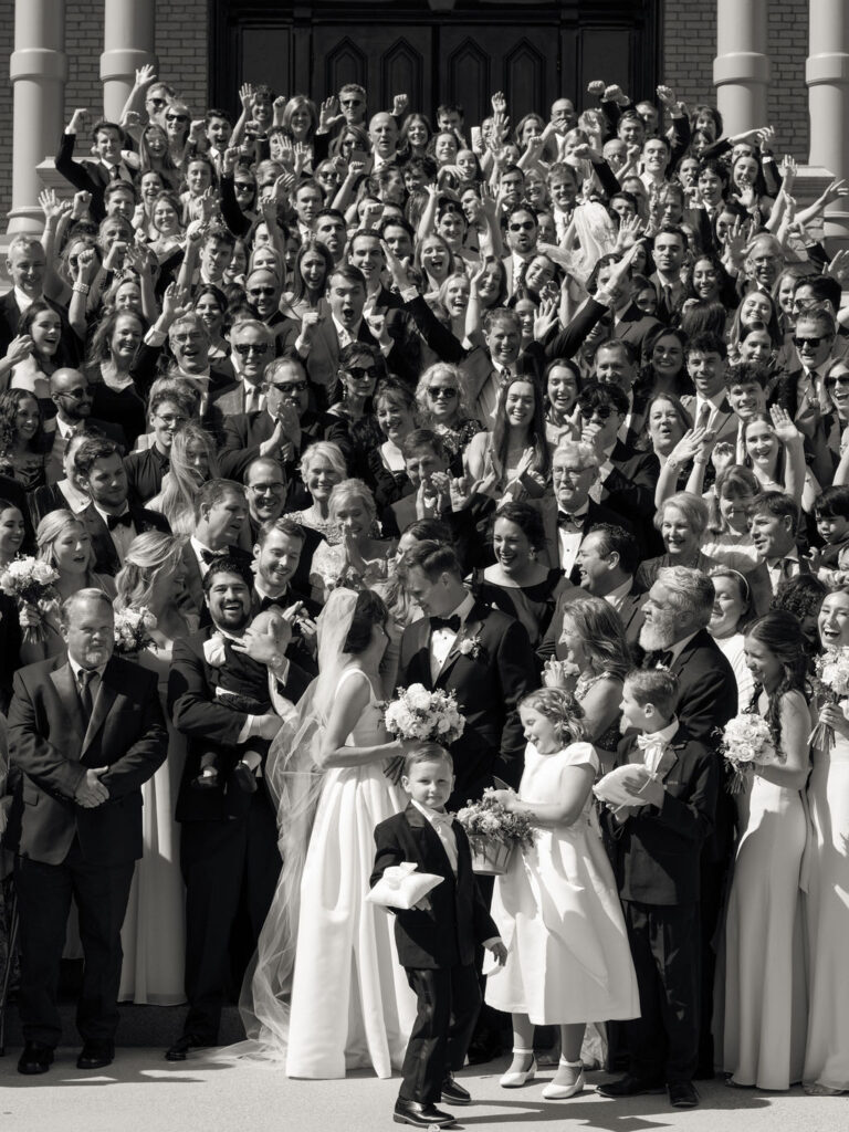 Black and white group shot outside of the church from a Notre Dame Basilica wedding ceremony