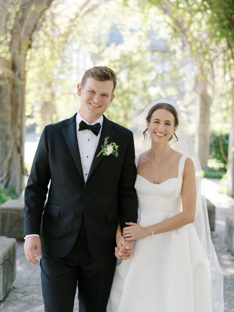 Bride and groom smiling during their Notre Dame wedding portraits