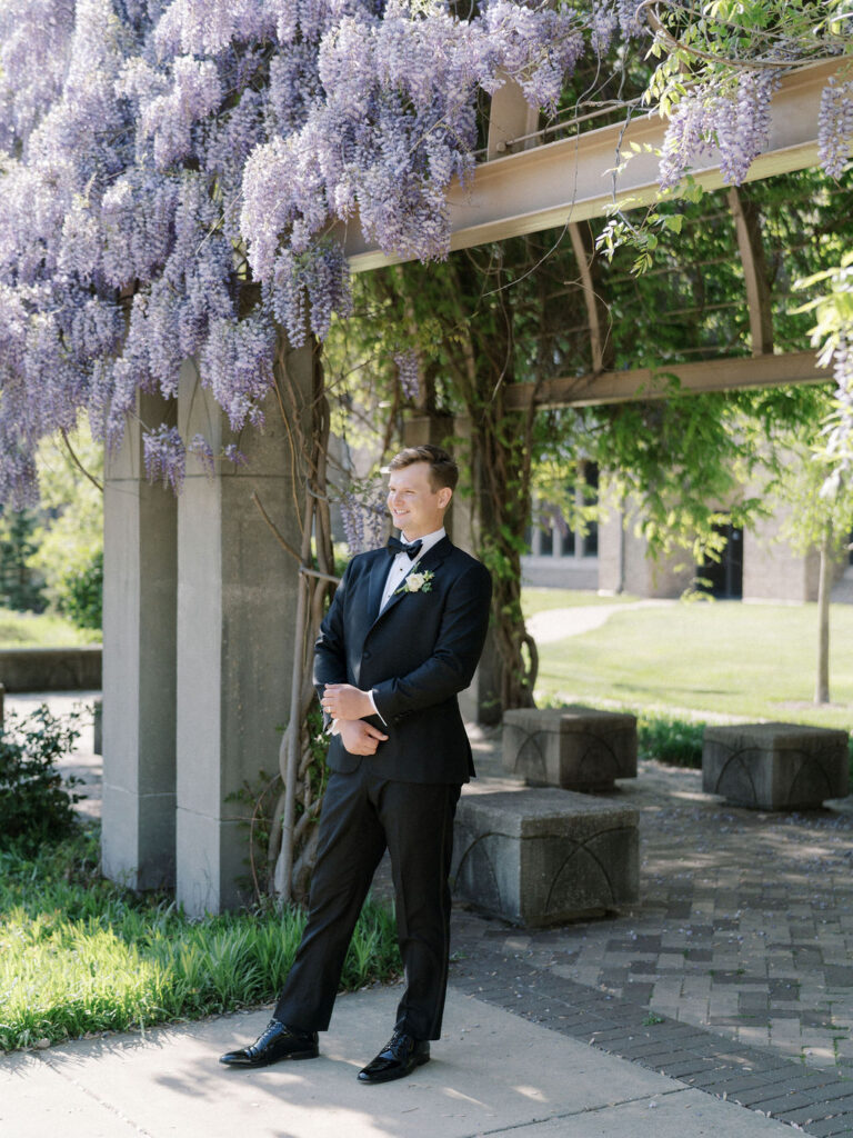 Groom posing outdoors for her Notre Dame wedding portraits