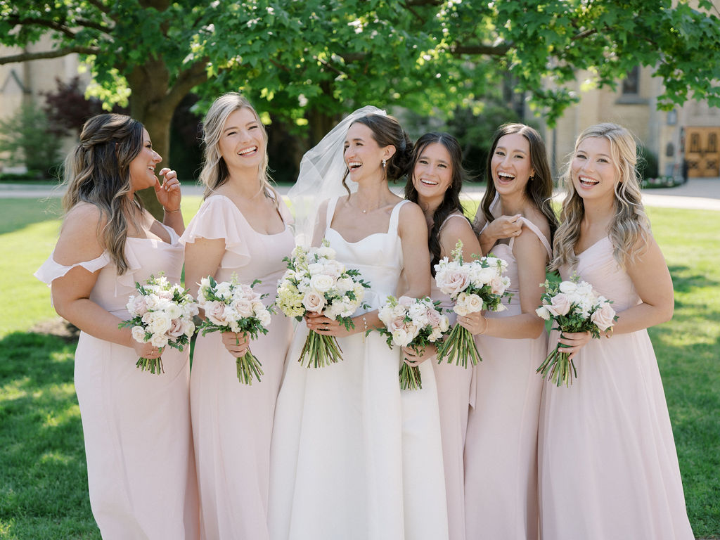 Bride and her bridesmaids laughing during Notre Dame wedding photos