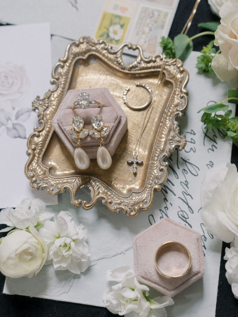 Florals and jewelry for a wedding details flat lay shot
