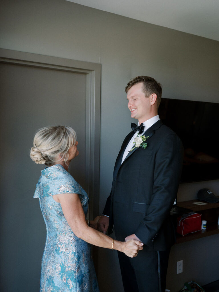 Groom sharing a joyful moment with his mom during getting ready