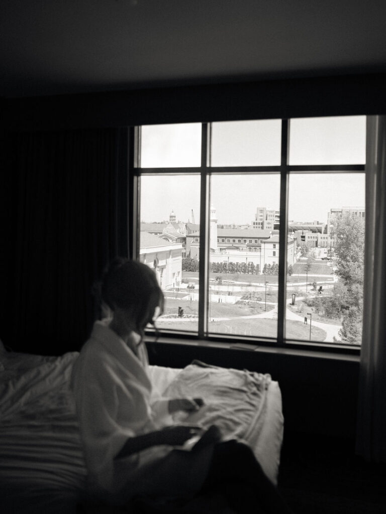 Bride reading a note from the groom as she gets ready for her University of Notre Dame wedding