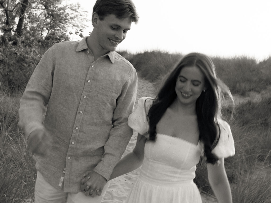 Black and white photo of a couple holding hands and walking the trails at Warren Dunes State Park