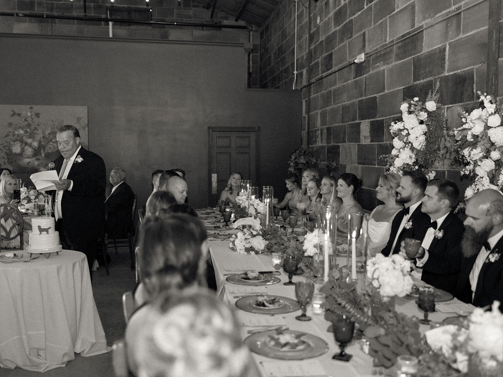 Black and white photo of father of the bride giving a speech