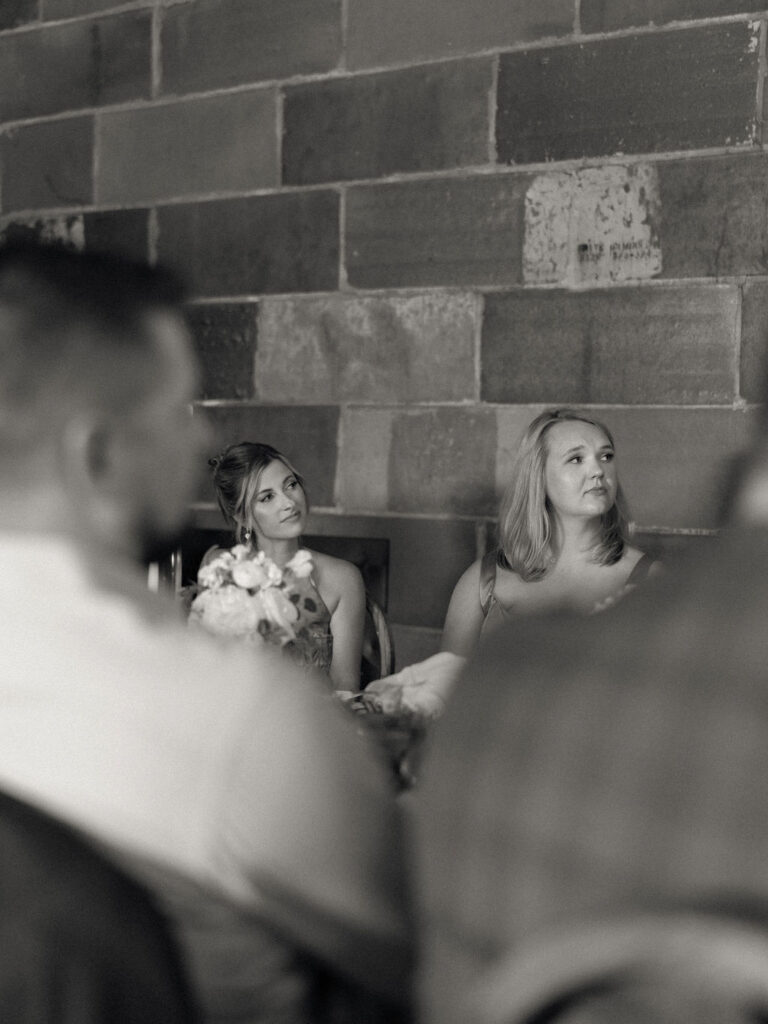 Candid wedding reception photo of guests getting emotional during speeches