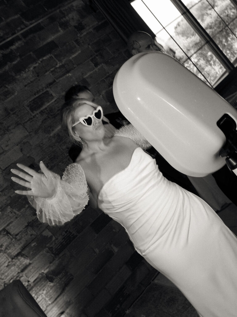 Bride taking a photo during the reception 