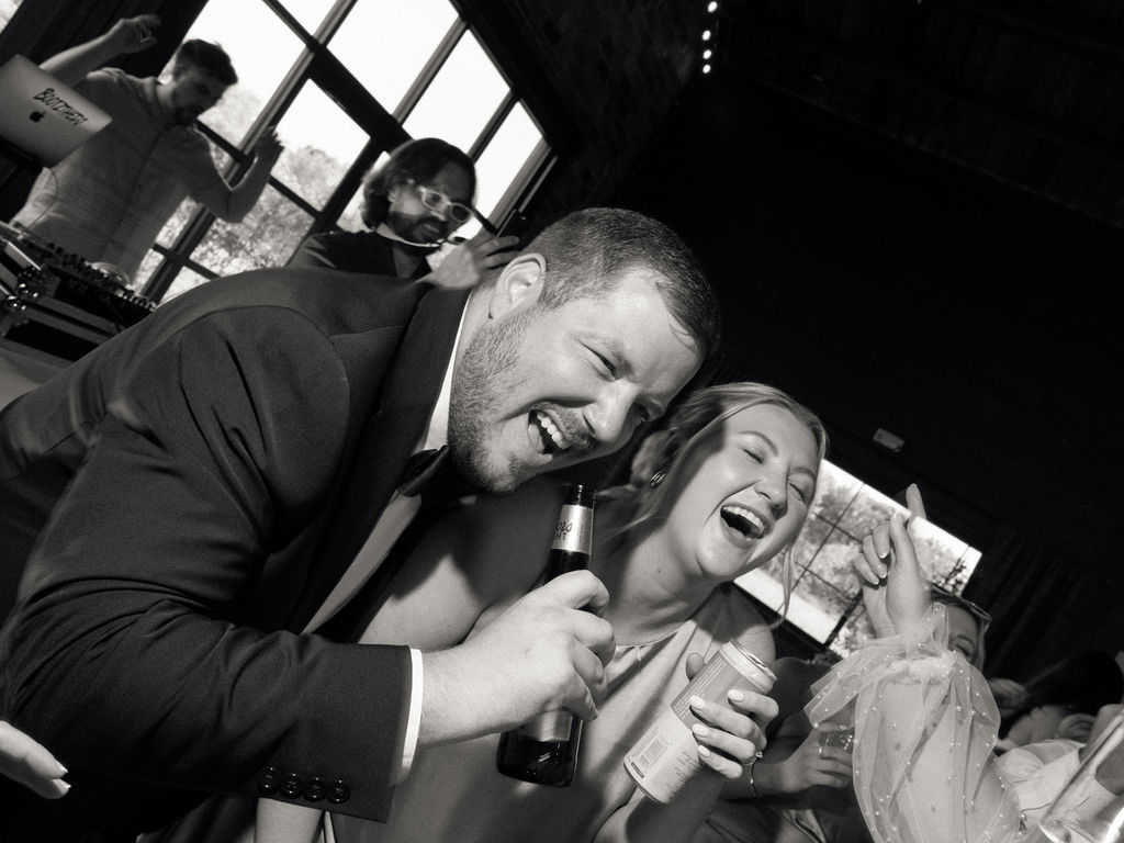 Wedding guests laughing during the reception