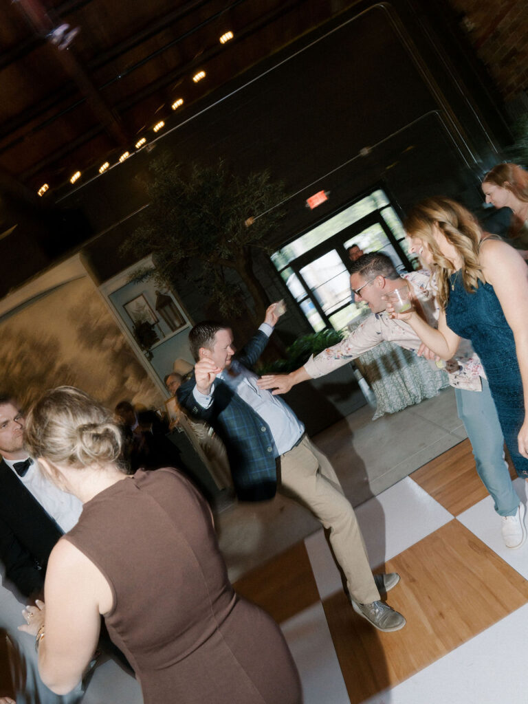 Guests on the dance floor during a reception at The Pickle Factory at The Millhaven