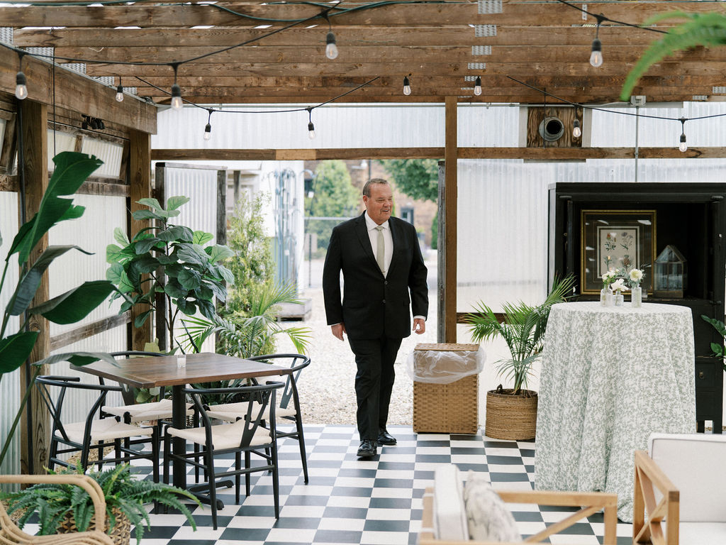 Father of the bride walking in to share a first look with his daughter 