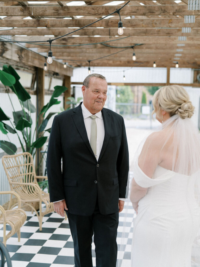 Bride and her father sharing a first look in The Greenhouse at The Millhaven