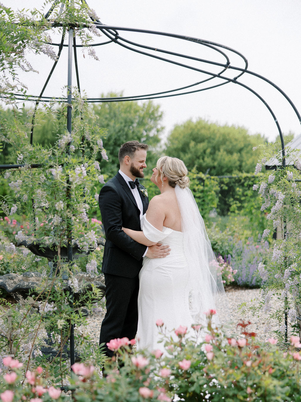 Outdoor bride and grooms portraits in the garden at The Millhaven in Marshall, Michigan
