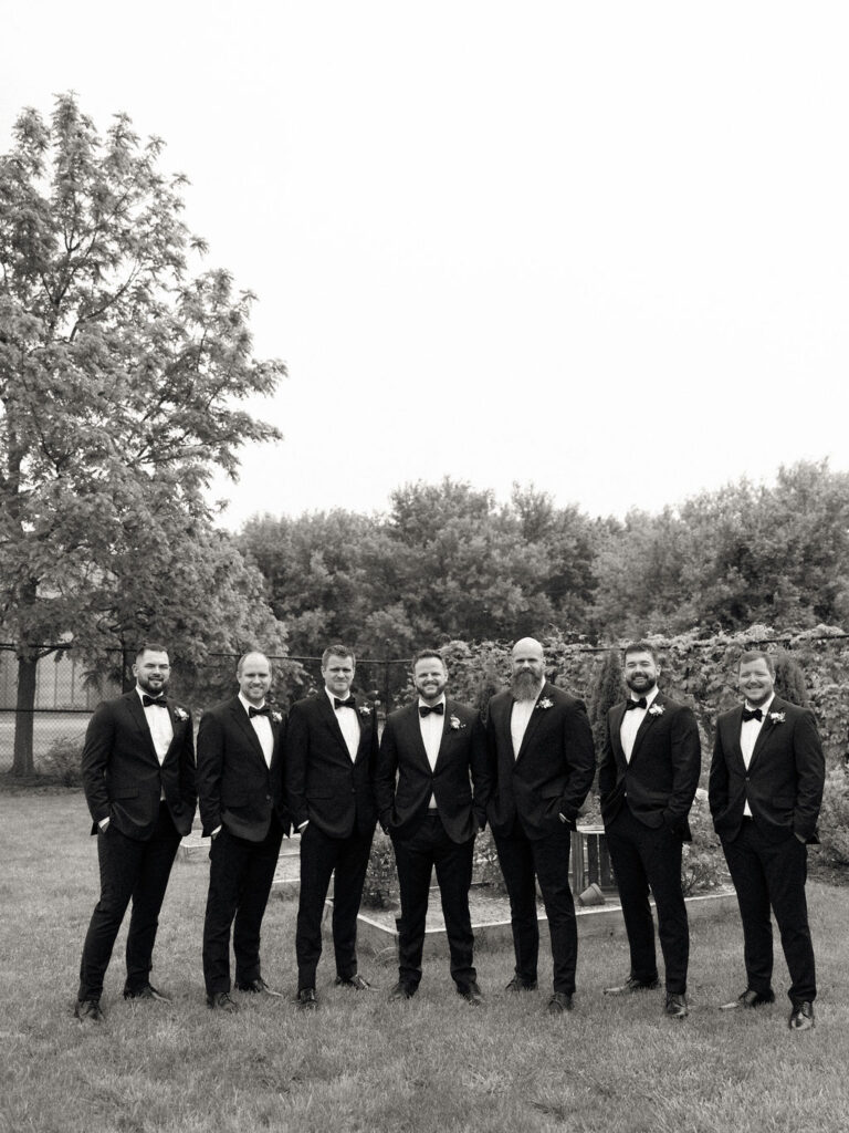 Black and white outdoor groom and groomsmen portrait at The Millhaven