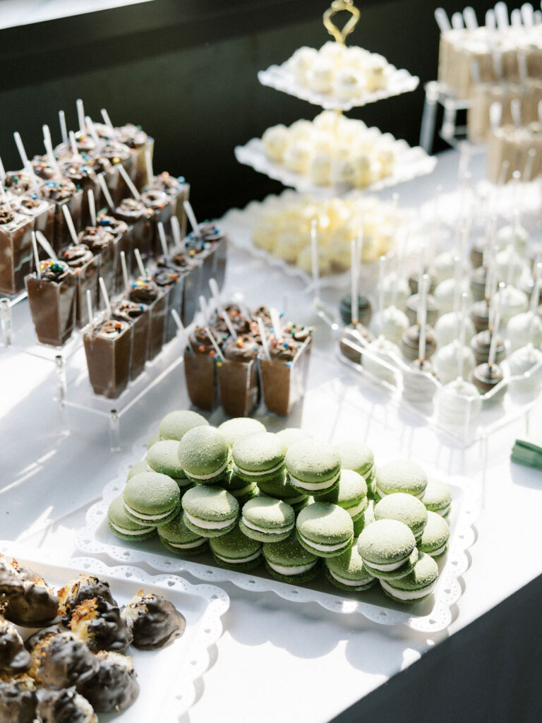 Wedding dessert table with macaroons, cake pops, and other desserts 