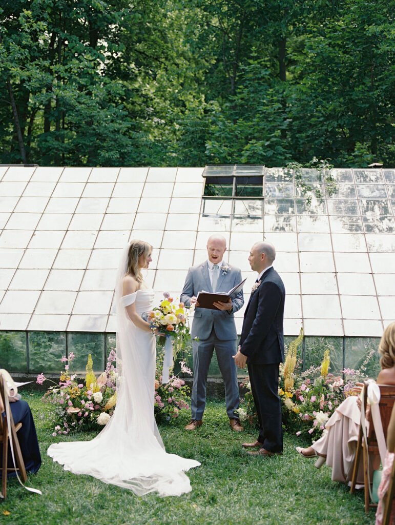 Bride and groom standing at the altar during their Glass House Community wedding