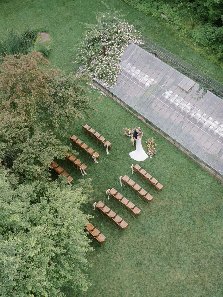 Aerial view of The Glass House Community ceremony setup surrounded by greenery.