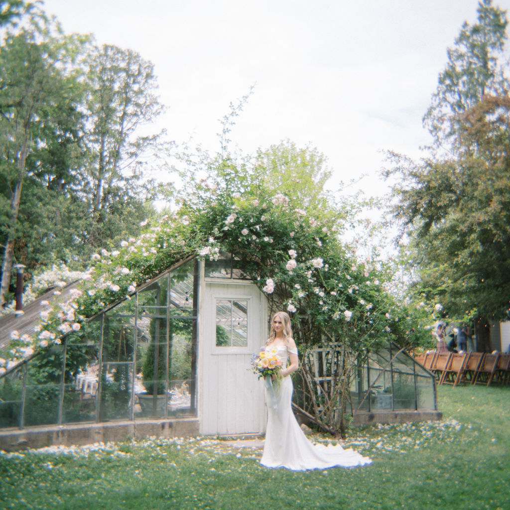 Outdoor bridal portraits in front of the Greenhouse from a Glass House Community wedding in Michigan