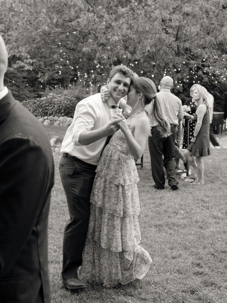 Black and white photo of guests dancing during a Glass House Community wedding reception in Michigan