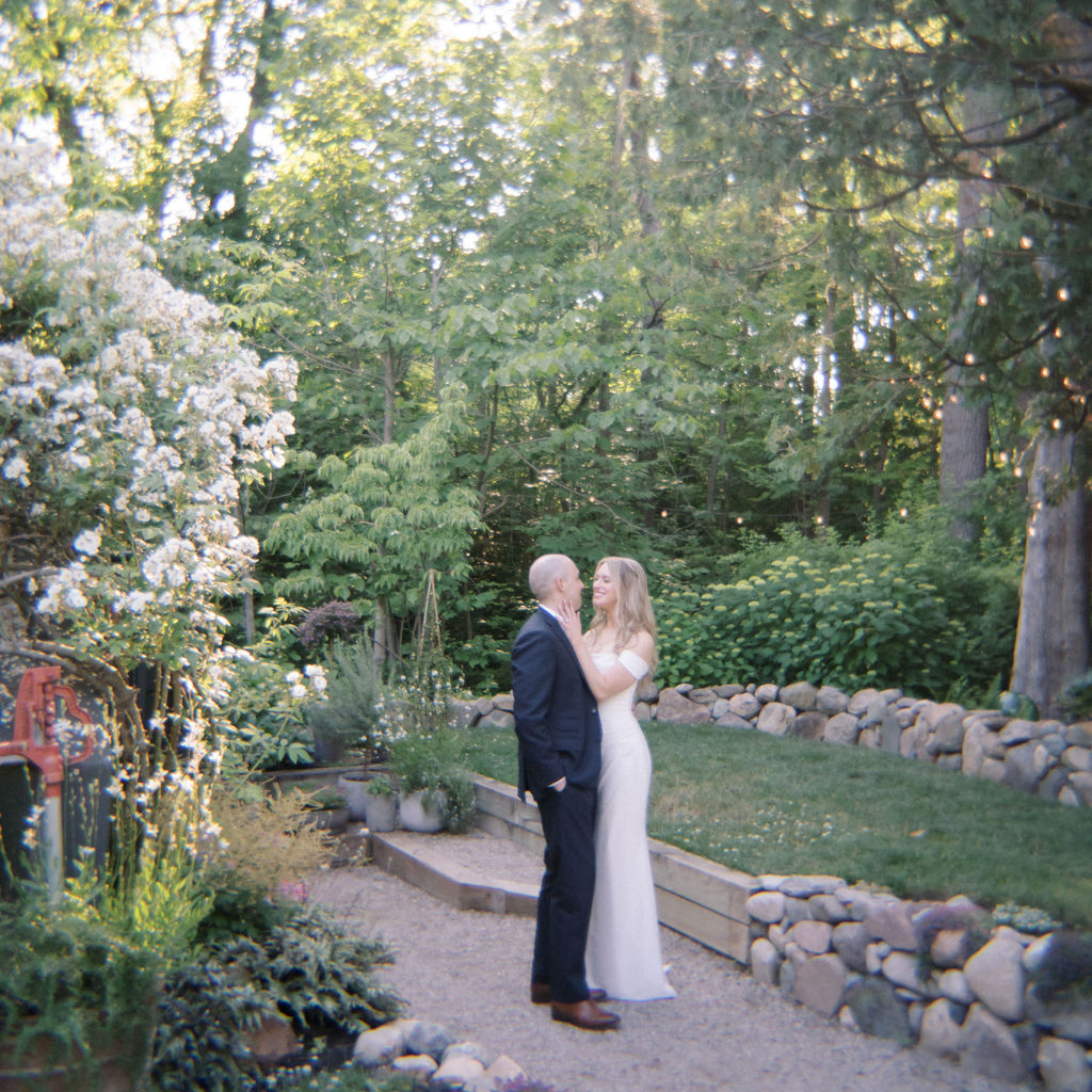 Film photo of a bride and groom posing at Glass House Community wedding venue in Michigan