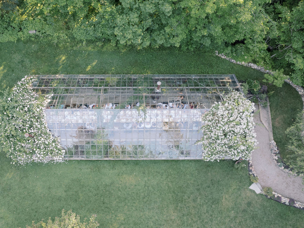 Aerial view of a reception inside the greenhouse at Glass House Community wedding venue in Michigan