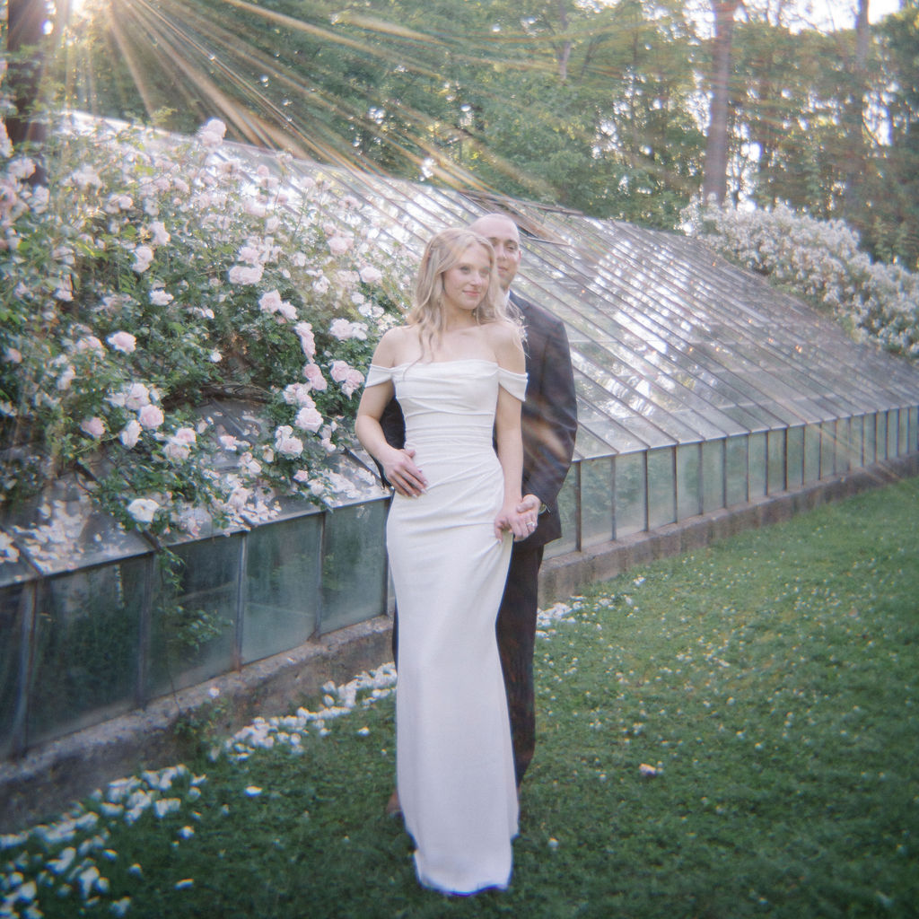 Couple posing outside of Glass House Community wedding venue in Michigan