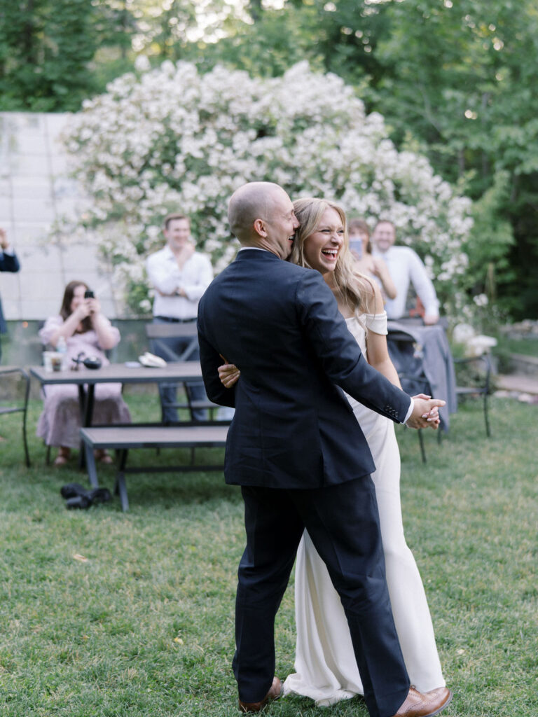 Bride and groom sharing their first dance during their Glass House Community wedding reception
