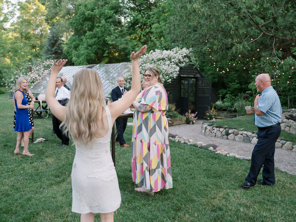 Bride showing off her wedding reception dress to guests