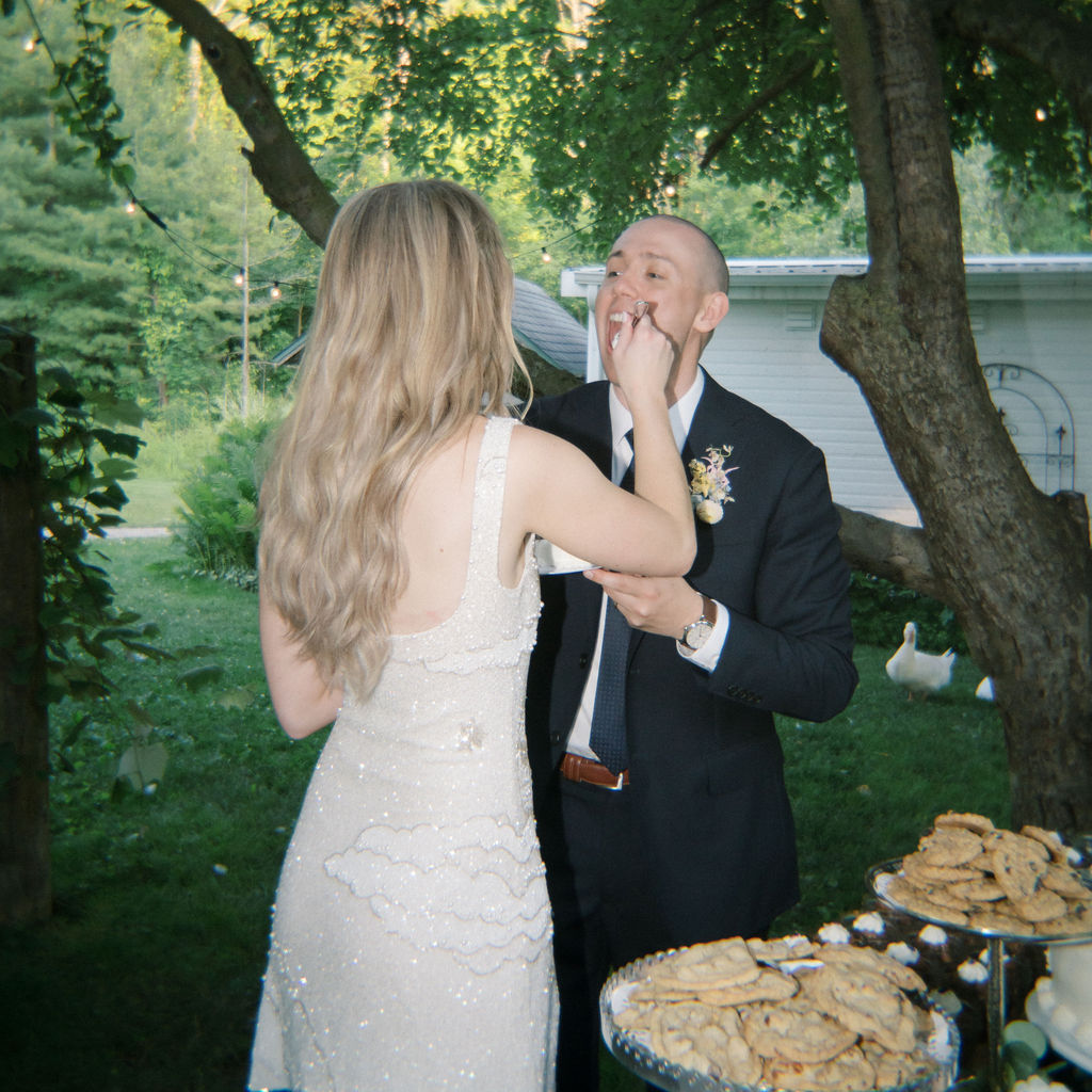 Bride and groom feeding each other cake during their reception