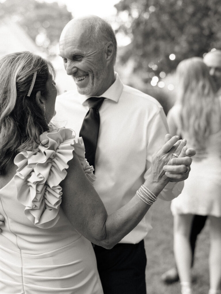 Black and white photo of guests dancing during a Glass House Community wedding reception in Michigan
