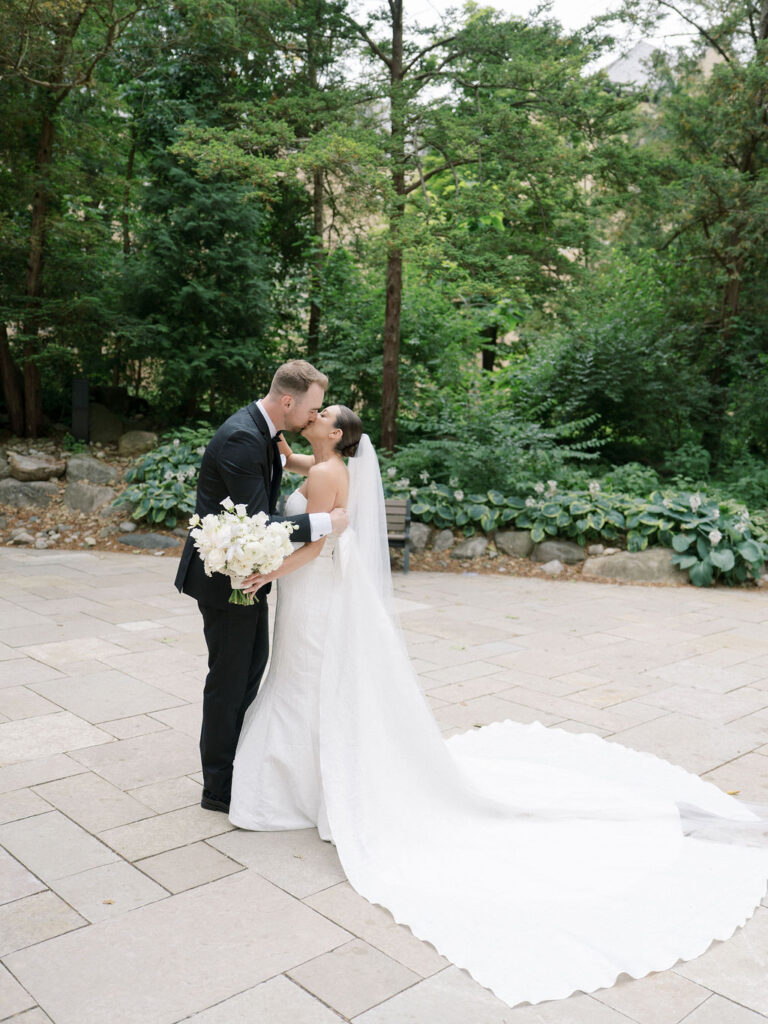 Bride and groom kissing during their first look at the Grotto for their Saint Mary's Notre Dame wedding