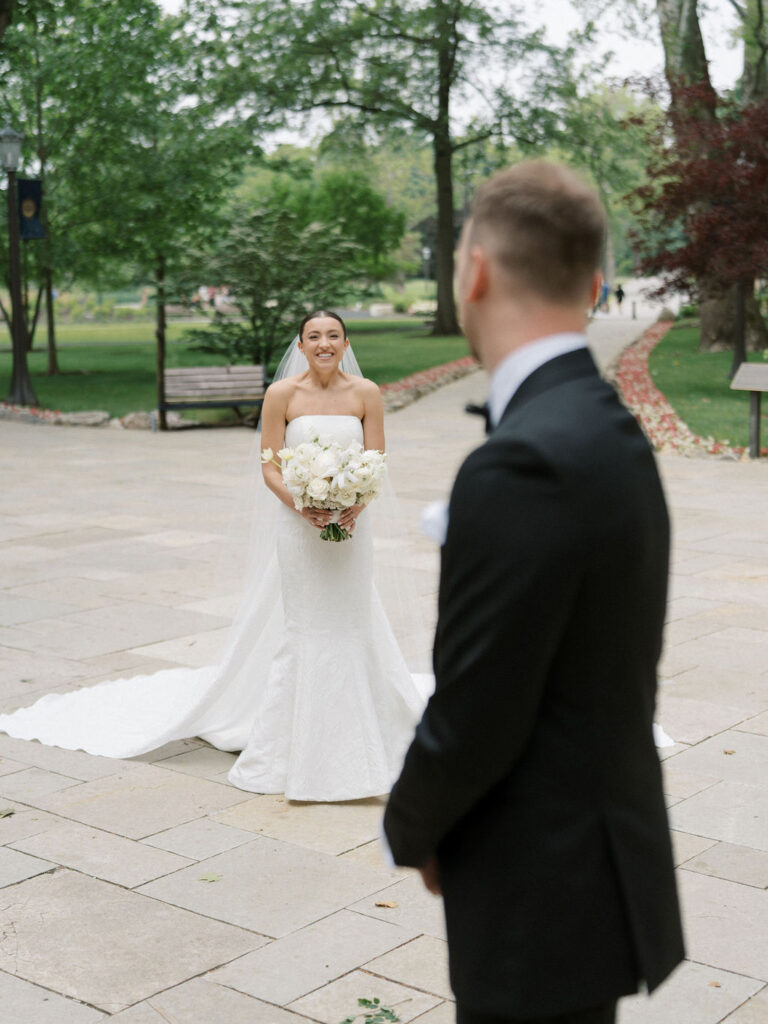 Bride and groom smiling during emotional first look at the Grotto at Notre Dame – Cynthia Mae Photo.