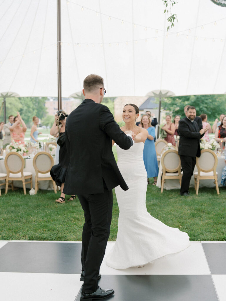 Bride and groom entering their tented Saint Mary’s Notre Dame wedding reception