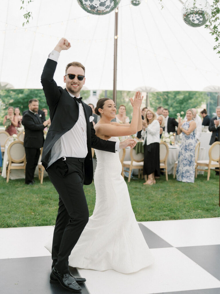 Bride and groom entering their tented Saint Mary’s Notre Dame wedding reception